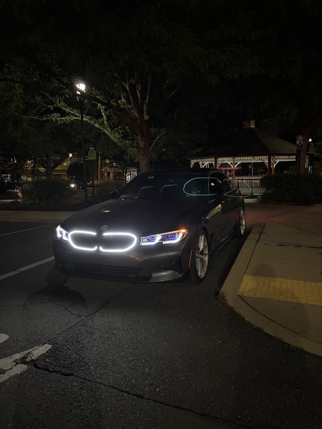 Ev's Mineral Gray BMW 330i xDrive parked at night