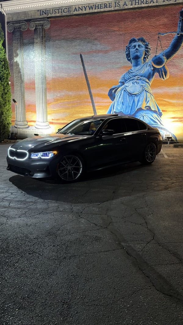 BCSC Build 001 — side profile of @g20ev's Mineral Gray BMW 330i xDrive at the mural