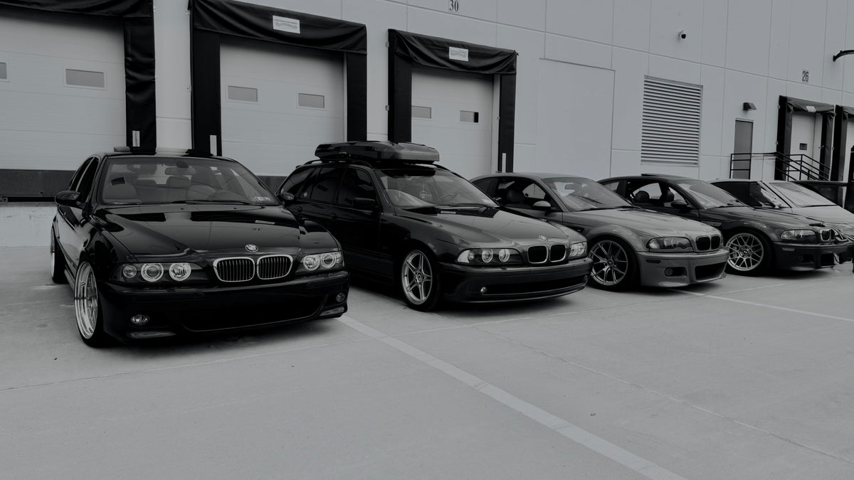 Black and silver BMWs lined up at a car meet